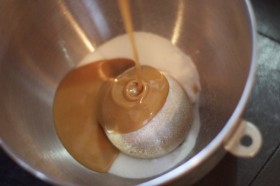 Adding the melted peanut butter to the sugars