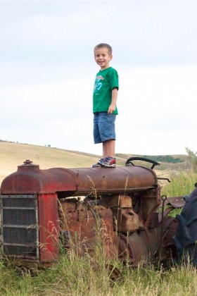 Tyson thinks he is the man up on that tractor.