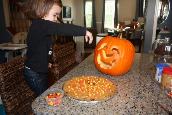 kid helping with cookie cake