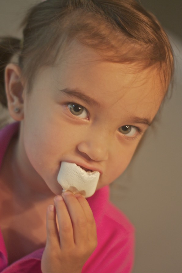 girl eating marshmallows